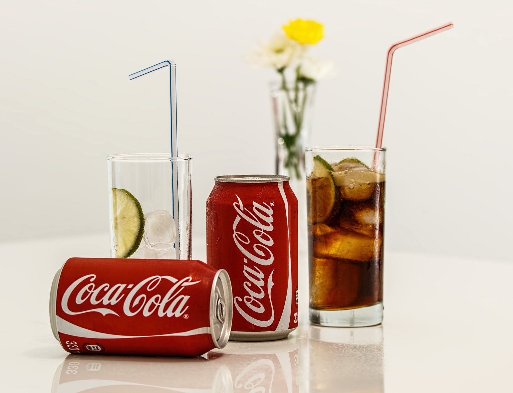 coca cola cans and glasses with lines
