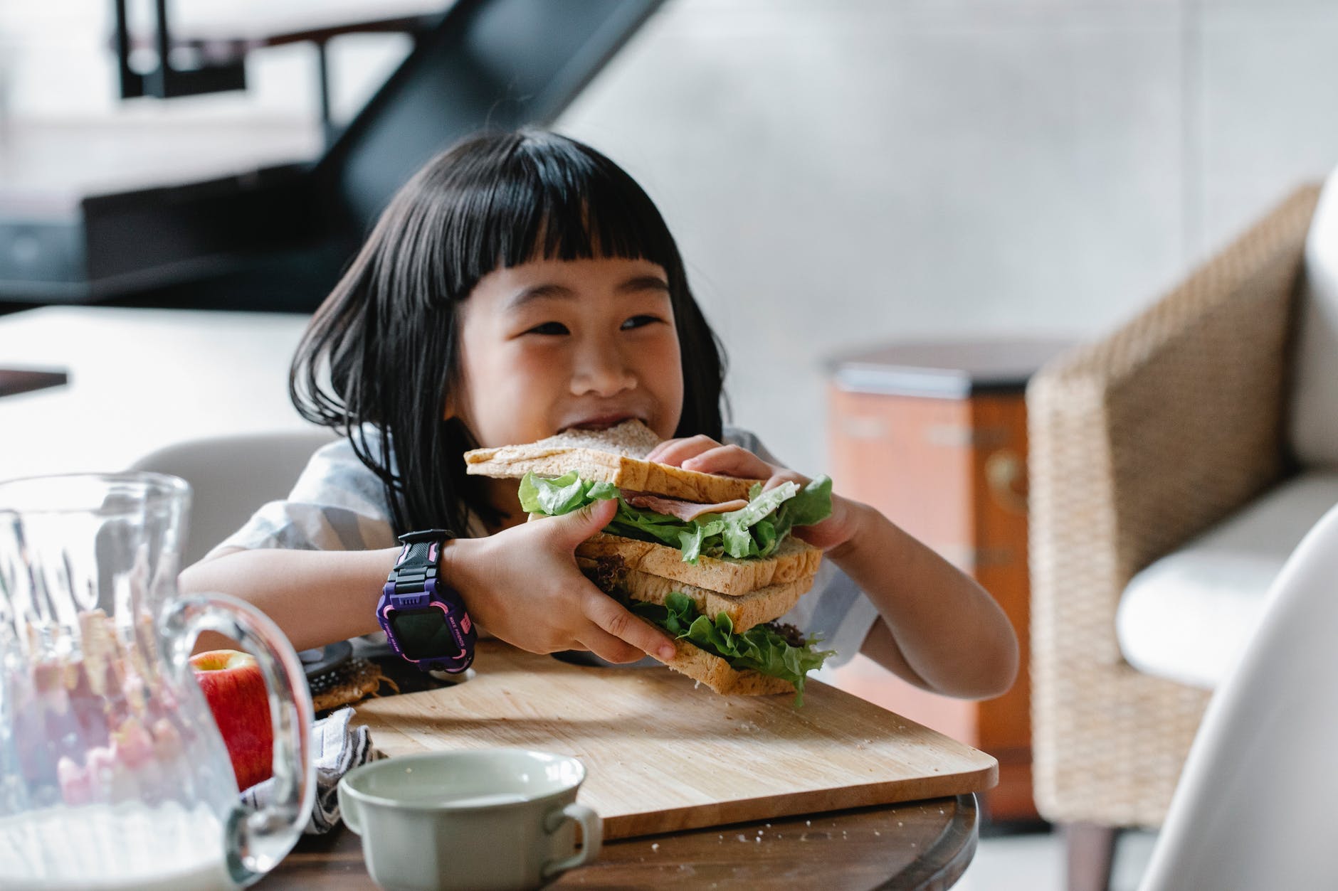 little girl eating huge delicious sandwich